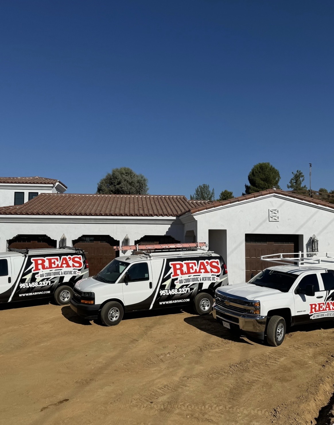 Rea's wrapped fleet in front of a Spanish-revival custom estate