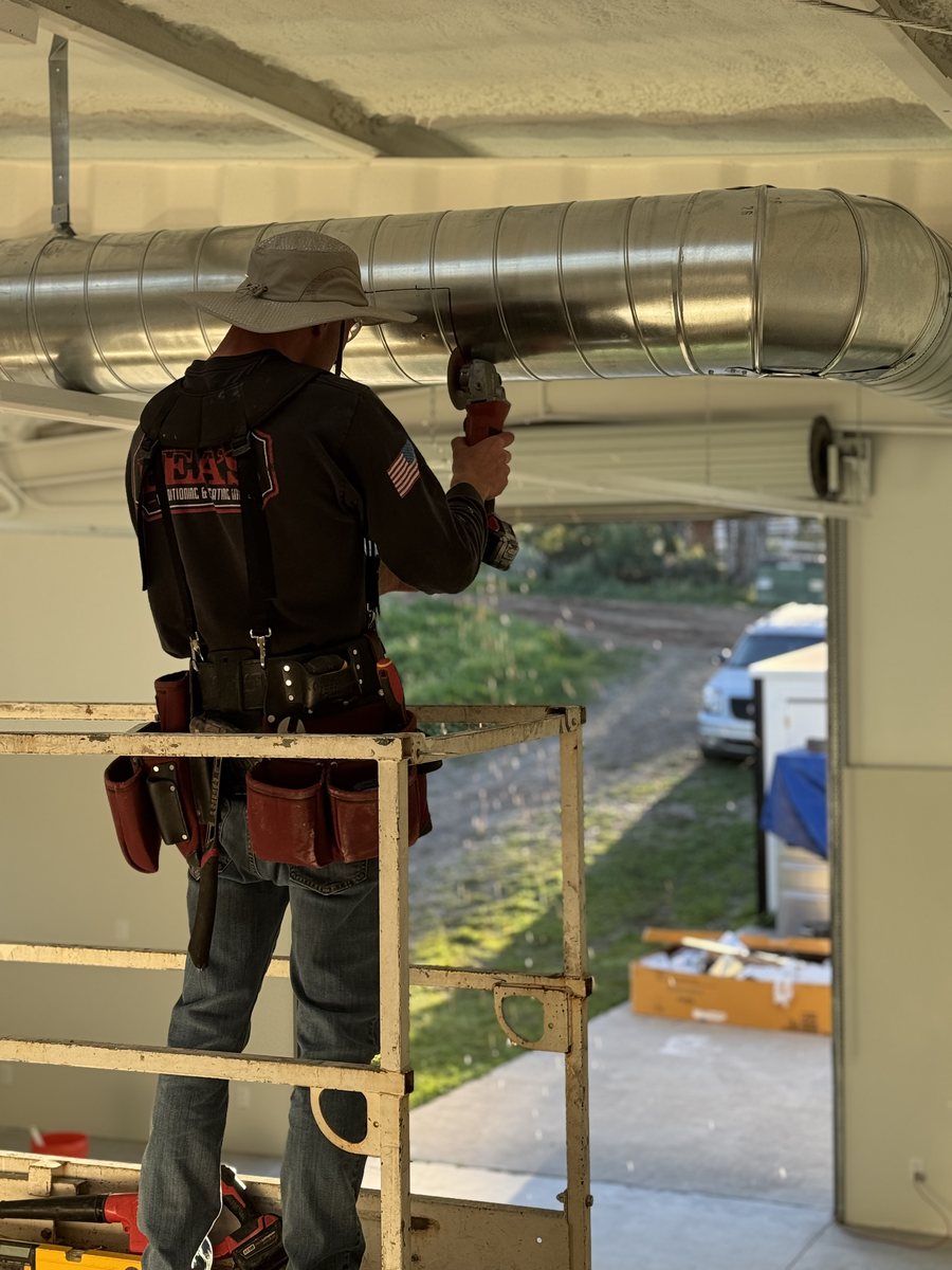 Close-up of Rea's technician fabricating custom spiral galvanized ductwork